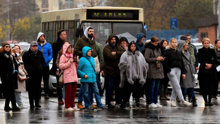 People stand in silence near the railway station in Novi Sad on November 15, 2024, two weeks after 14 people died when a roof at the city’s train station collapsed - AFPpix