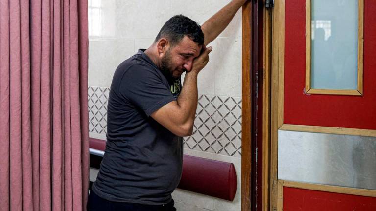 A relative reacts as the body of Thameen Dawabsheh, 35-year-old Palestinian reportedly killed by settler gunfire in Duma, south of Nablus, is moved from Rafidiya hospital in the occupied West Bank city of Nablus on August 13, 2025. (Photo by JAAFAR ASHTIYEH / AFP)