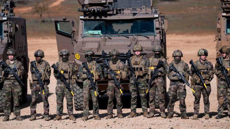 French soldiers stand in line in front of their military vehicles following a combat simulation during the ‘’Scorpion Days’’ manuevers at the French army Canjuers camp - AFPpix