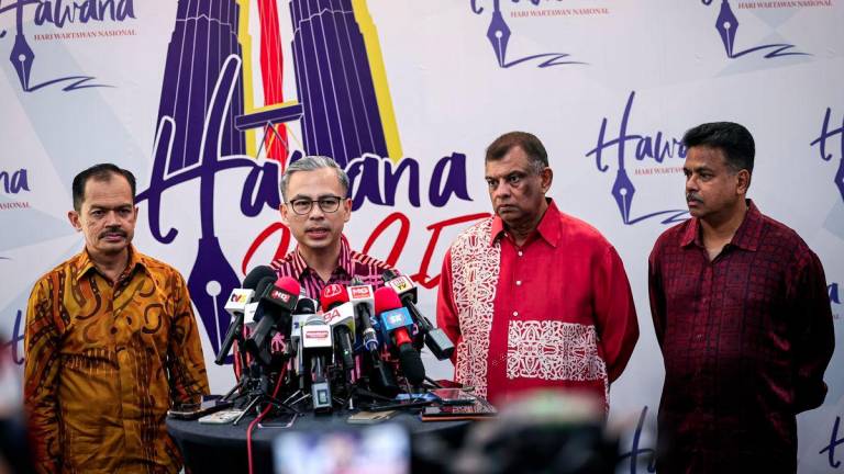 Communications Minister Datuk Fahmi Fadzil (second, left) and AirAsia co-founder and Capital A Bhd Chief Executive Officer Tan Sri Tony Fernandes (second, right) address a press conference after the official launch of National Journalists’ Day (HAWANA) 2025 at Dewan Merdeka, World Trade Centre Kuala Lumpur (WTCKL), today. - BERNAMAPIX