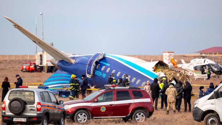 Emergency specialists work at the crash site of an Azerbaijan Airlines passenger jet near the western Kazakh city of Aktau on December 25, 2024. (Photo by Issa Tazhenbayev / AFP)