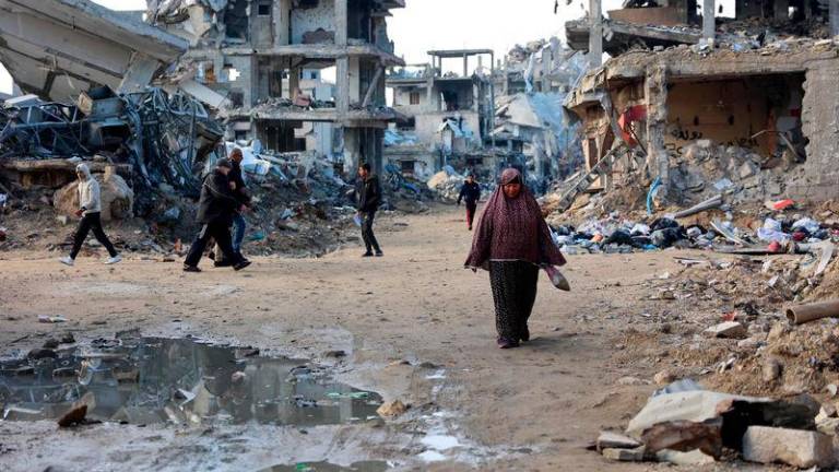 Palestinians walks amid the destruction in the Shujaiya neighbourhood of Gaza City - AFPpix