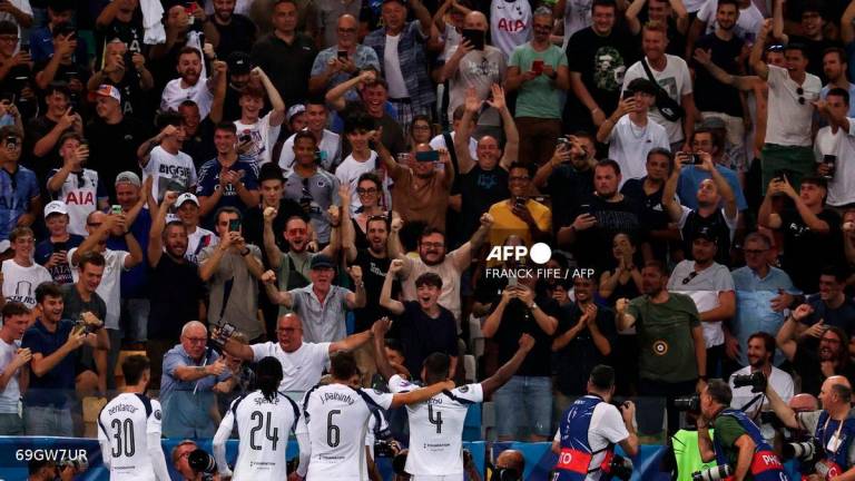 Tottenham's players celebrate in front of their fans after scoring their second goal during the 2025 UEFA Super Cup final football match between Paris Saint-Germain (FRA) and Tottenham Hotspur FC (ENG) at the Friuli stadium, in Udine, on August 13, 2025. - AFP