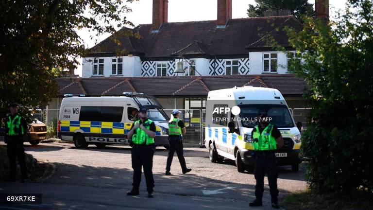 Police officers stand outside the The Bell Hotel, believed to be housing asylum seekers, in Epping, northeast of London, on August 8, 2025, as protests are expected from far right groups. (Photo by HENRY NICHOLLS / AFP)