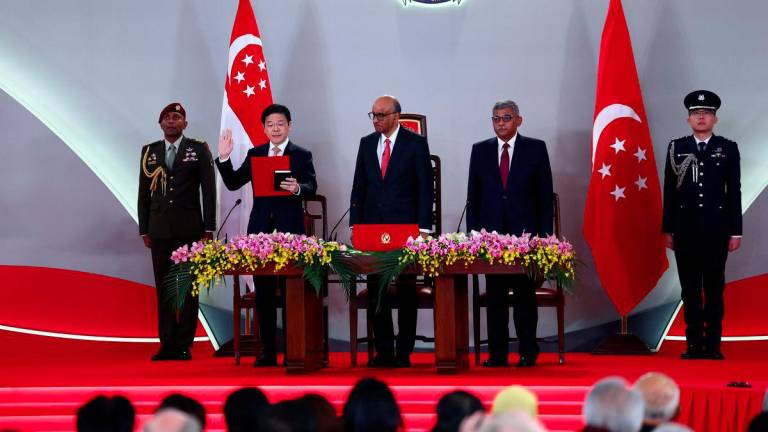 Lawrence Wong is sworn in as Singapore's Prime Minister during a swearing-in ceremony at the Istana, in Singapore, May 23, 2025. - REUTERSPIX