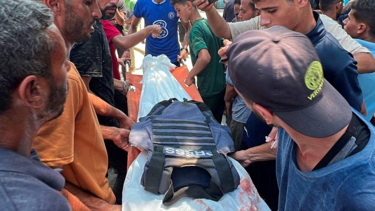 Mourners carry the body Palestinian cameraman Hussam al-Masri, who was a contractor for Reuters, after he was killed along with other journalists and people in Israeli strikes on Nasser hospital, in Khan Younis in the southern Gaza Strip, August 25, 2025. - REUTERSPIX