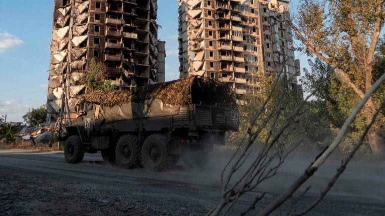 A military truck drives past destroyed residential buildings in Avdiivka, a Russian-controled Donetsk region of Ukraine on September 27, 2025, amid the ongoing Russian-Ukrainian conflict. - AFPPIX
