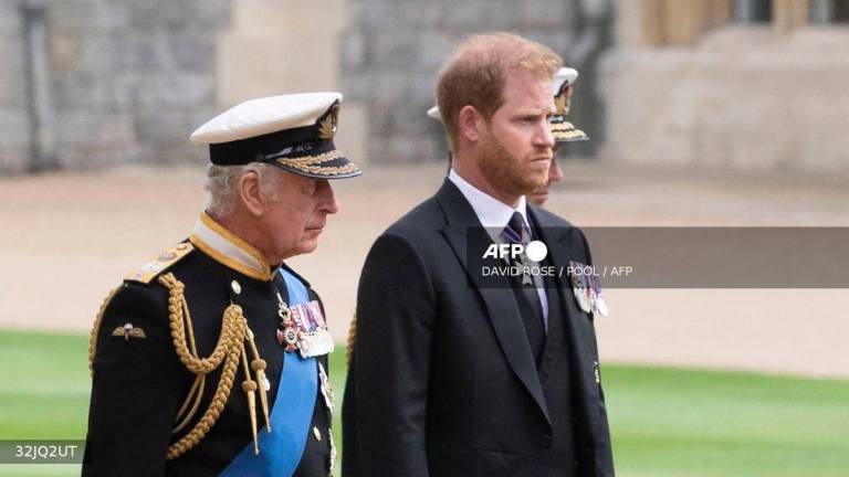 Britain's King Charles III (L) walks with his son Britain's Prince Harry, Duke of Sussex as they arrive at St George's Chapel inside Windsor Castle on September 19, 2022, ahead of the Committal Service for Britain's Queen Elizabeth II. - POOL via AFP