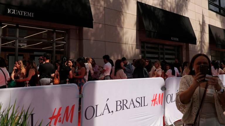 People queue to enter the first H&amp;M fast-fashion store in Sao Paulo, Brazil August 23, 2025. - REUTERS