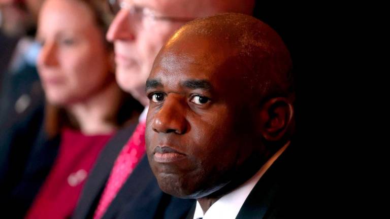 Britain’s Foreign Secretary David Lammy (R) reacts as he sits with Britain’s Defence Secretary John Healey (C) and other officials during the Australia-UK Ministerial Consultations (AUKMIN) meeting in Sydney on July 25, 2025. - AFPPIX
