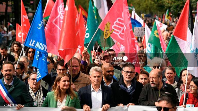 National secretary of French left-wing The Ecologistes party Marine Tondelier (C-L), National secretary of French far-left Communist party (PCF) Fabien Roussel (C) and First secretary of French left-wing Socialist party (PS) Olivier Faure (C-R) lead a march asking for the recognition of the State of Palestine and the end of the genocide, in Paris on September 21, 2025. - AFP