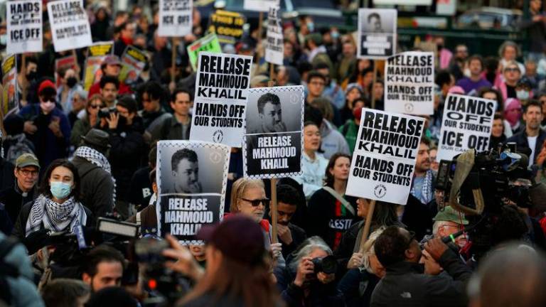 Demonstrators hold placards during a protest following the arrest by US immigration agents of Palestinian student protester Mahmoud Khalil at Columbia University, at Foley Square in New York City - REUTERSpix