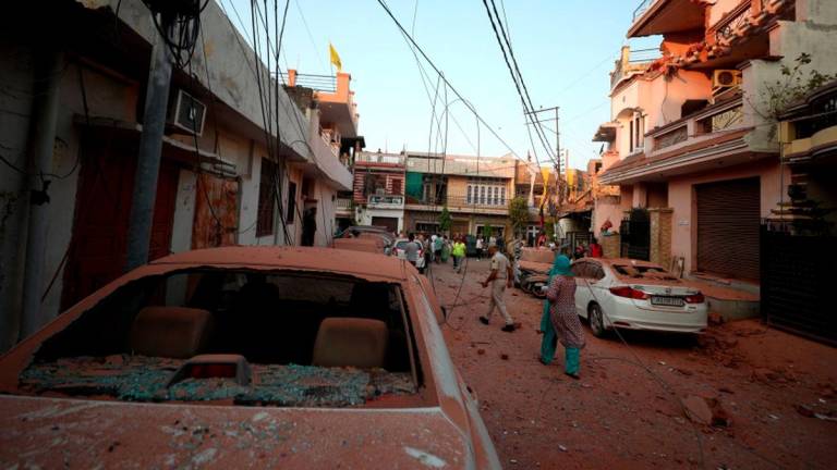 Damaged vehicles are seen in the neighbourhood, following Pakistan's military operation against India, in Rehari, Jammu, May 10, 2025. - REUTERSPIX