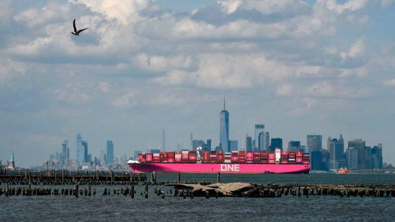 An Ocean Network Express (ONE) container ship sails Manhattan’s skyline as it leaves New York harbor on May 3, 2025 in New York City. AFPpix