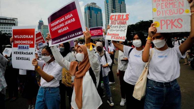 Activists take part in a rally to support women’s rights outside the National Monument complex in Jakarta on March 2022 - REUTERSpix