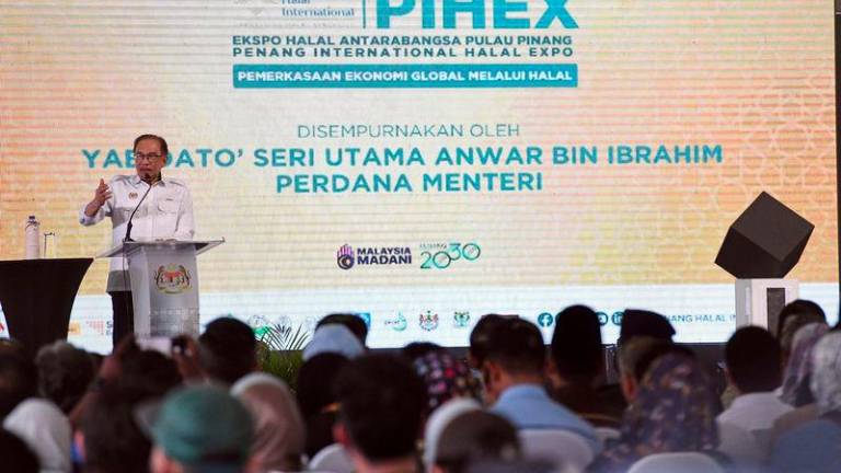 Prime Minister Datuk Seri Anwar Ibrahim deliver his speech during an opening of the Penang International Halal Expo (PIHEX) 2024 held at the Gravitas parking lot today. - BERNAMAPIX