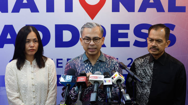 Communications Minister Datuk Fahmi Fadzil at a press conference after attending the National Addressing Conference 2025 at the World Trade Centre Kuala Lumpur (WTCKL) today. Also present were his Deputy Minister of Communications Teo Nie Ching and the Ministry’s Secretary-General Datuk Mohamad Fauzi Md Isa. – BERNAMA