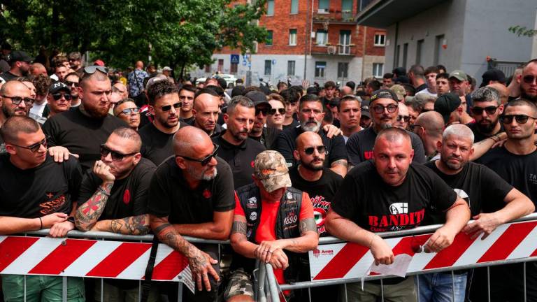 AC Milan 'ultras' supporters wait outside a high-security courtroom to show solidarity with fellow ultras awaiting a verdict in a court case involving soccer fans linked to both Inter Milan and AC Milan, who are suspected of having ties to the 'Ndrangheta mafia, in Milan, Italy, June 17, 2025. - REUTERSPIX