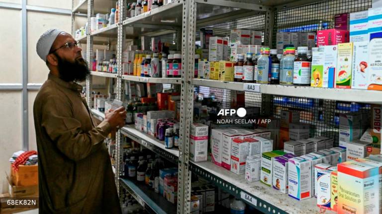 An employee checks the stock of medicines at a pharmacy store in Hyderabad on July 31, 2025. - AFP