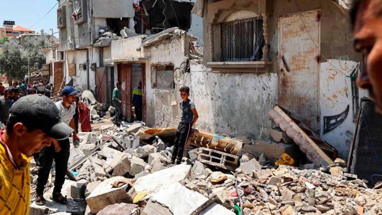 People inspect the damage at the site of an Israeli strike that targeted a house in the Nuseirat camp for Palestinian refugees in the central Gaza Strip on June 1, 2025. (Photo by Eyad BABA / AFP)