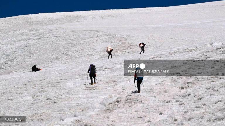 This picture shows members of the expedition Pamir-Ice-Memory climbing up Pamir Glacier, on September 25, 2025 in Kon Chukurbashi, eastern Tadjikistan. - AFP
