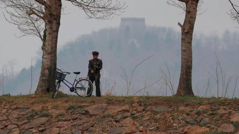 A North Korean soldier keeps watch at the Yalu River in Sinuiju, North Korea, which borders Dandong in China’s Liaoning province - REUTERSpix