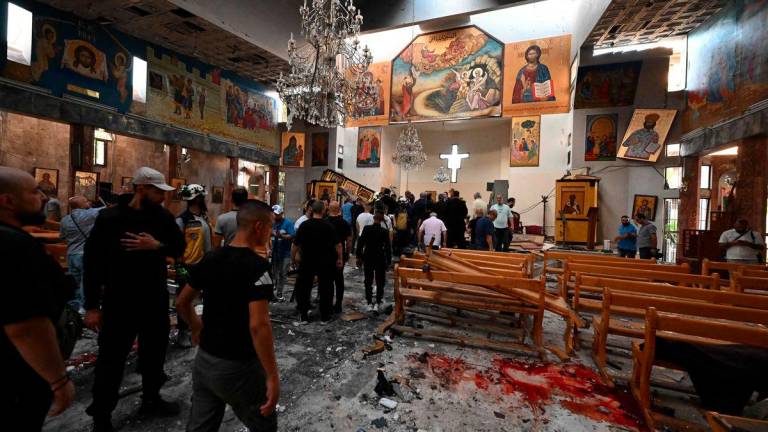People and rescuers inspect the damage at the site of a reported suicide attack at the Saint Elias church in Damascus’ Dwelaa area on June 22, 2025. (Photo by LOUAI BESHARA / AFP)