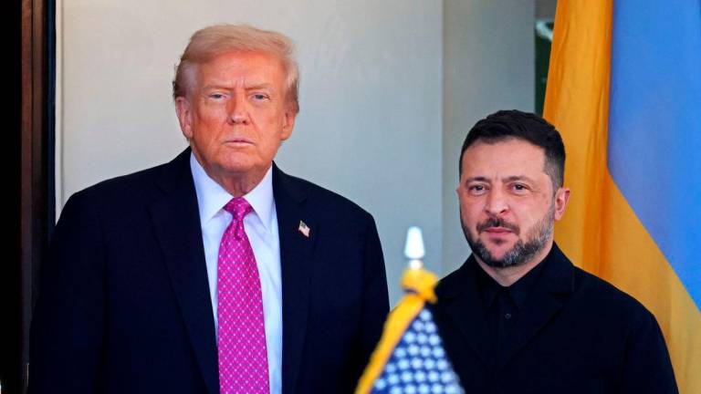 US President Donald Trump welcomes Ukrainian President Volodymyr Zelensky as he arrives for a meeting at the White House in Washington, DC, on October 17, 2025. (Photo by TOM BRENNER / AFP)