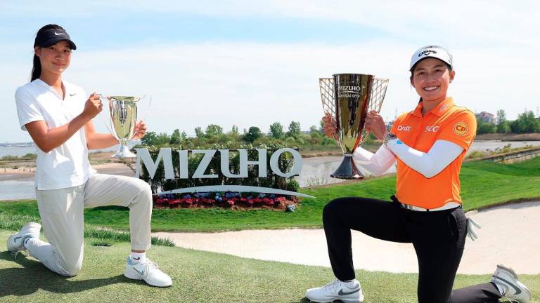 Low amateur Aphrodite Deng (left) and tournament winner Jeeno Thitikul pose with their trophies after the Mizuho Americas Open 2025. – Getty Images