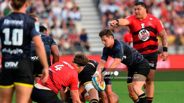 Hurricanes’ Cameron Roigard (2nd R) passes the ball during round one of the Super Rugby Pacific match between the Crusaders and Hurricanes at Apollo Projects Stadium in Christchurch on February 14, 2025. (Photo by Sanka Vidanagama / AFP)