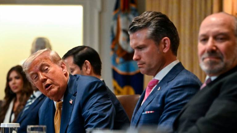US President Donald Trump speaks alongside Secretary of Defence Pete Hegseth and Secretary of Commerce Howard Lutnick during a Cabinet meeting in the White House in Washington. – AFPPIC