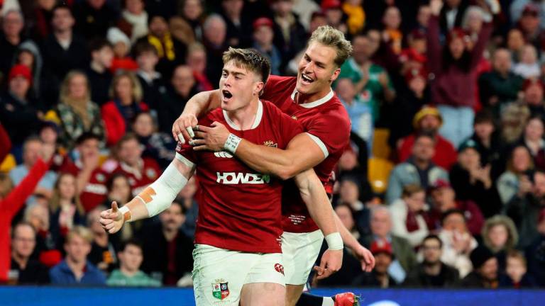 British and Irish Lions’ Tommy Freeman (L) celebrates his try with a teammate Duhan van der Merwe during the tour match between Queensland Reds and British and Irish Lions at Suncorp Stadium in Brisbane on July 2, 2025. (Photo by DAVID GRAY / AFP)