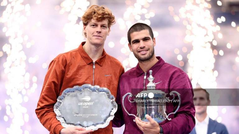 Spain’s Carlos Alcaraz (R) and Italy’s Jannik Sinner (L) pose for a photo after their men's singles final tennis match on day fifteen of the US Open tennis tournament at the USTA Billie Jean King National Tennis Center in New York City, on September 7, 2025. - AFP