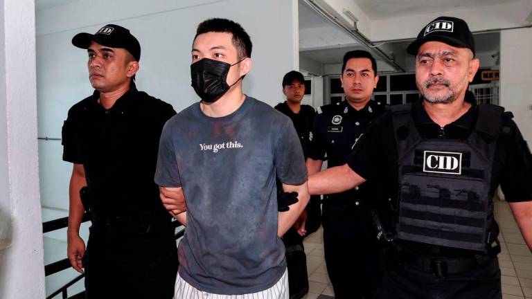 Law student at a private university, Chew Hong Joe (second from left), was brought to the Sessions Court here today on five charges of committing mischief by fire and one charge of causing the death of a senior citizen last July. – BERNAMA