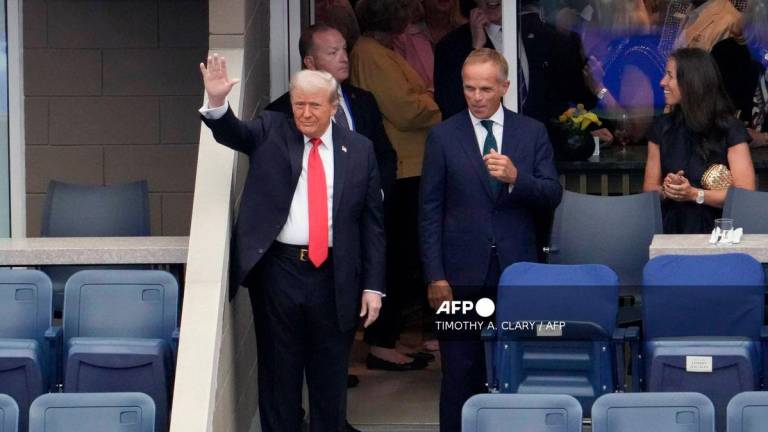 US President Donald Trump (L) waves as he arrives to attend the men's singles final tennis match between Spain’s Carlos Alcaraz and Italy’s Jannik Sinner on the last day of the US Open tennis tournament at the USTA Billie Jean King National Tennis Center in New York City, on September 7, 2025. - AFP