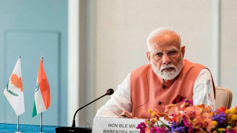 India’s Prime Minister Narendra Modi attends a business forum in Limassol on June 15, 2025. (Photo by Iakovos Hatzistavrou / POOL / AFP)
