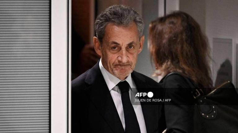 Former French president Nicolas Sarkozy leaves after the verdict in his trial for illegal campaign financing from Libya for his successful 2007 presidential bid, at the Tribunal de Paris courthouse in Paris, on September 25, 2025. - AFP