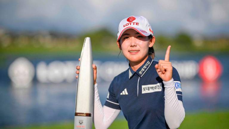 Youmin Hwang of South Korea poses with the winners trophy following her victory in the final round of the LOTTE Championship presented by Hoakalei 2025 at Hoakalei Country Club on October 04, 2025. (Photo by Orlando Ramirez / GETTY IMAGES NORTH AMERICA / AFP)