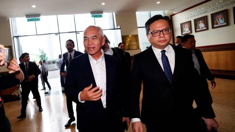 Sindumin assemblyman Datuk Dr Yusof Yacob (left) arriving at the Kota Kinabalu court complex to face his charge. - Bernama pic