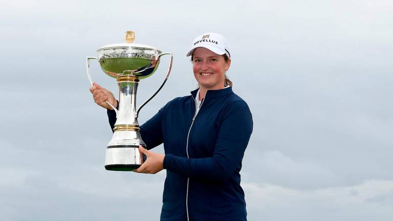 Lottie Woad of England poses with the trophy following victory of the ISPS HANDA Women's Scottish Open. – Kate McShane/Getty Images