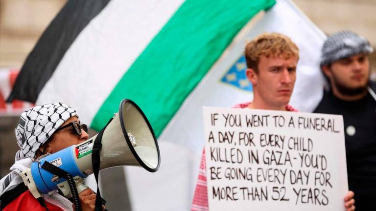 Pro-Palestinian supporters chant slogans and hold placards as they rally in front of the Foreign &amp; Commonwealth Office, in central London, on July 21, 2025. (Photo by Adrian DENNIS / AFP)