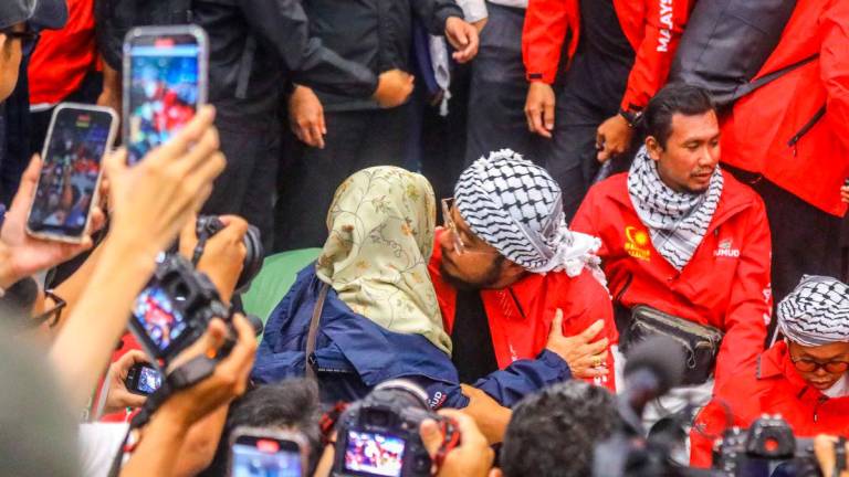 EMOTIONAL WELCOME ... One of the 23 Malaysian volunteers detained by Israeli forces during the Global Sumud Flotilla mission is greeted by a relative on arrival at the KL International Airport. – ADAM AMIR HAMZAH/THESUN