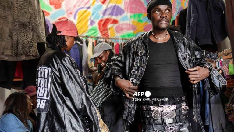 Models fit designs by kenyan fashion designer Morgan Azedy, a rising star among designers specialising in upcycling discarded fabrics and garments prior to a fashion show of various local designers dubbed 'Wasteland Gikomba fashion' in Nairobi on October 9, 2025. - AFP