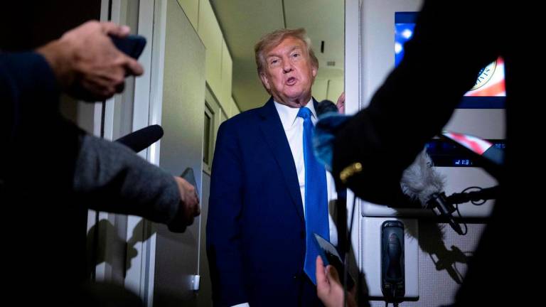 US President Donald Trump speaks to reporters about the G7 Summit aboard Air Force One while travelling back to Washington from Canada on June 16, 2025. (Photo by Brendan Smialowski / AFP)