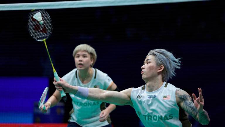 Malaysia’s Toh Ee Wei (L) and Chen Tang Jie play a point during their mixed doubles semi-final match against China’s Feng Yanzhe and Huang Dongping at the China Masters badminton tournament in Shenzhen, in China's southern Guangdong province on September 20, 2025. - AFP