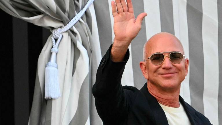 US founder of Amazon, Jeff Bezos waves as he leaves the Aman Hotel in Venice on June 25, 2025. (Photo by Stefano Rellandini / AFP)