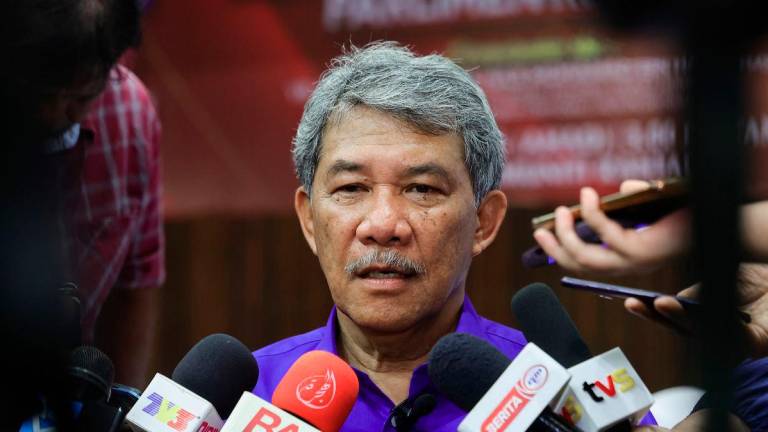 The Foreign Minister and Member of Parliament for Rembau, Datuk Seri Mohamad Hasan, speaking to the media after the donation presentation ceremony in the Rembau Parliament at the Rantau Community Hall today. - BERNAMA