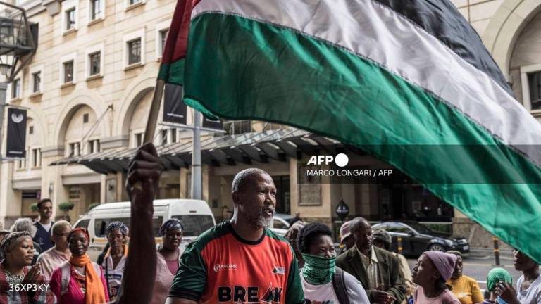 Mandla Mandela (C), a South African MP and the grandson of South African anti-apartheid hero Nelson Mandela, dances as he takes pat in a pro Palestinian demonstration outside the Sandton Convention Centre in Sandton, on February 13, 2025. - AFP