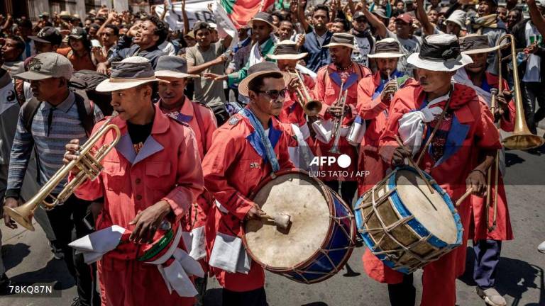 Members of a band play music as students dance and march in celebration toward a civil society rally in Antananarivo, on October 13, 2025. Soldiers and security forces joined hundreds celebrating in Madagascar's capital on October 13, 2025, hours before President Andry Rajoelina was due to address the nation following weeks of protests and growing calls for his resignation. - AFP