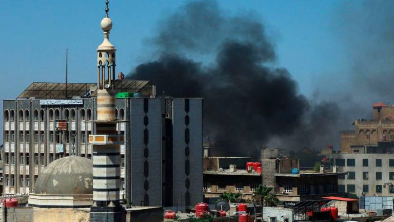 Smoke billows during clashes in the predominantly Druze city of Sweida on July 15, 2025. (Photo by Shadi AL-DUBAISI / AFP)